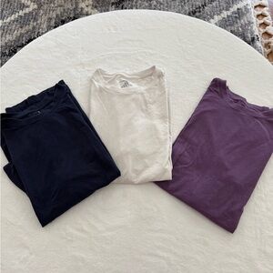 Set of Three Fabletics T-Shirts in Navy White, and Purple.
